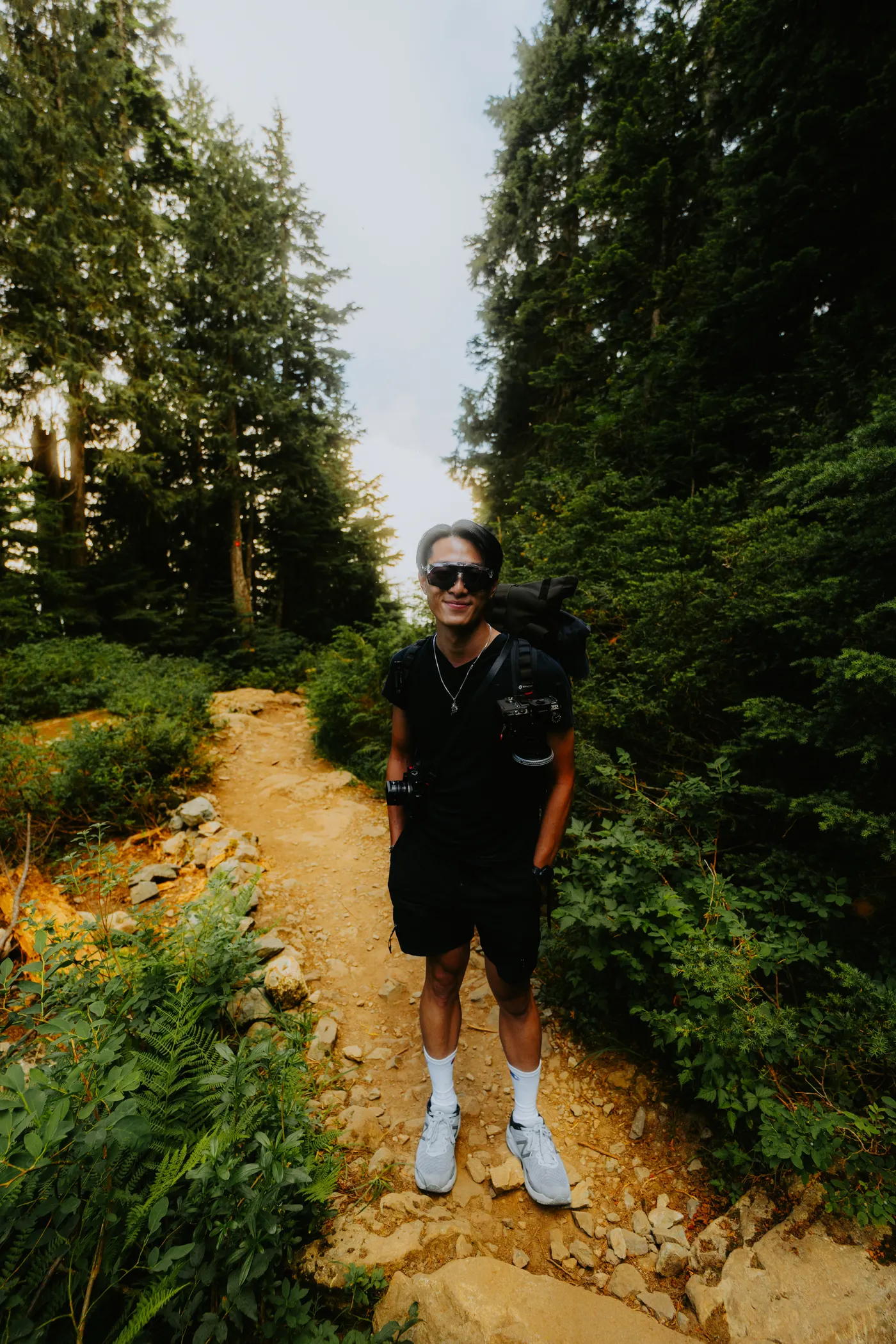 Man hiking with a backpack on a wooded trail