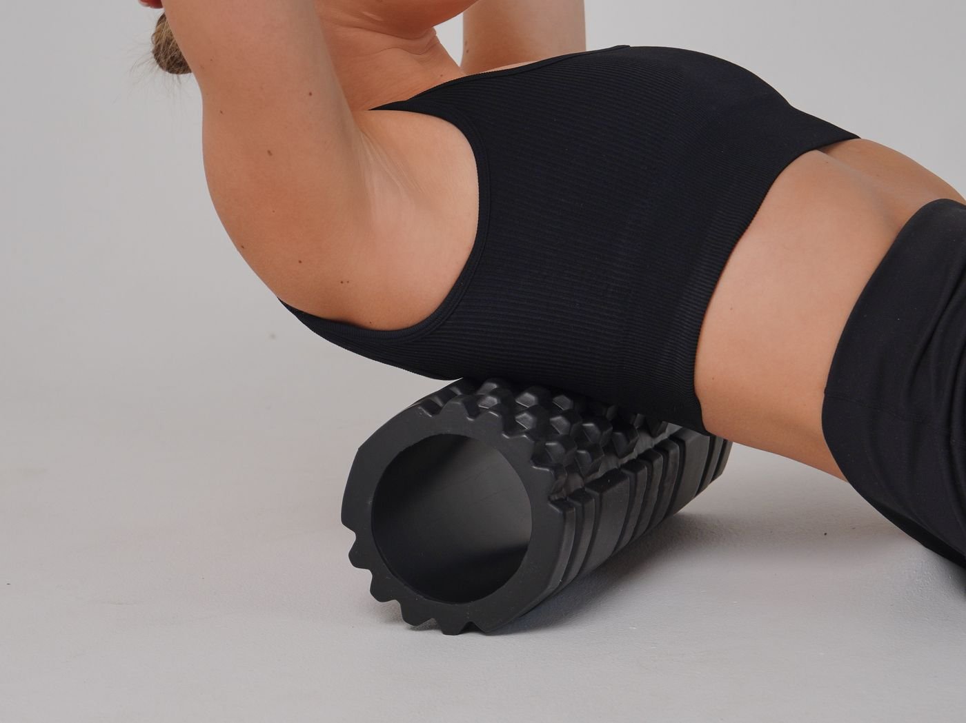 Woman using a foam roller for gentle post-training mobility work