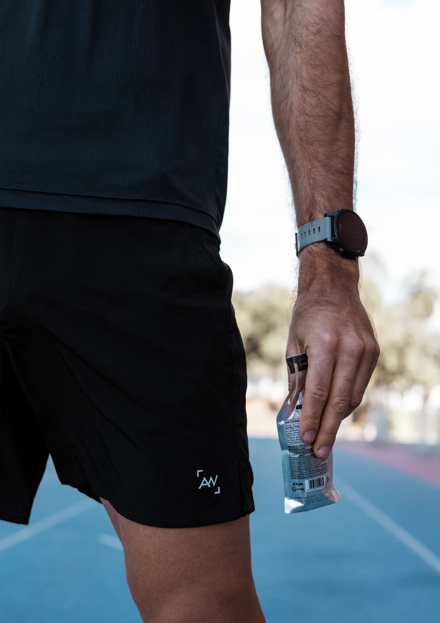 Athlete holding an energy gel during training