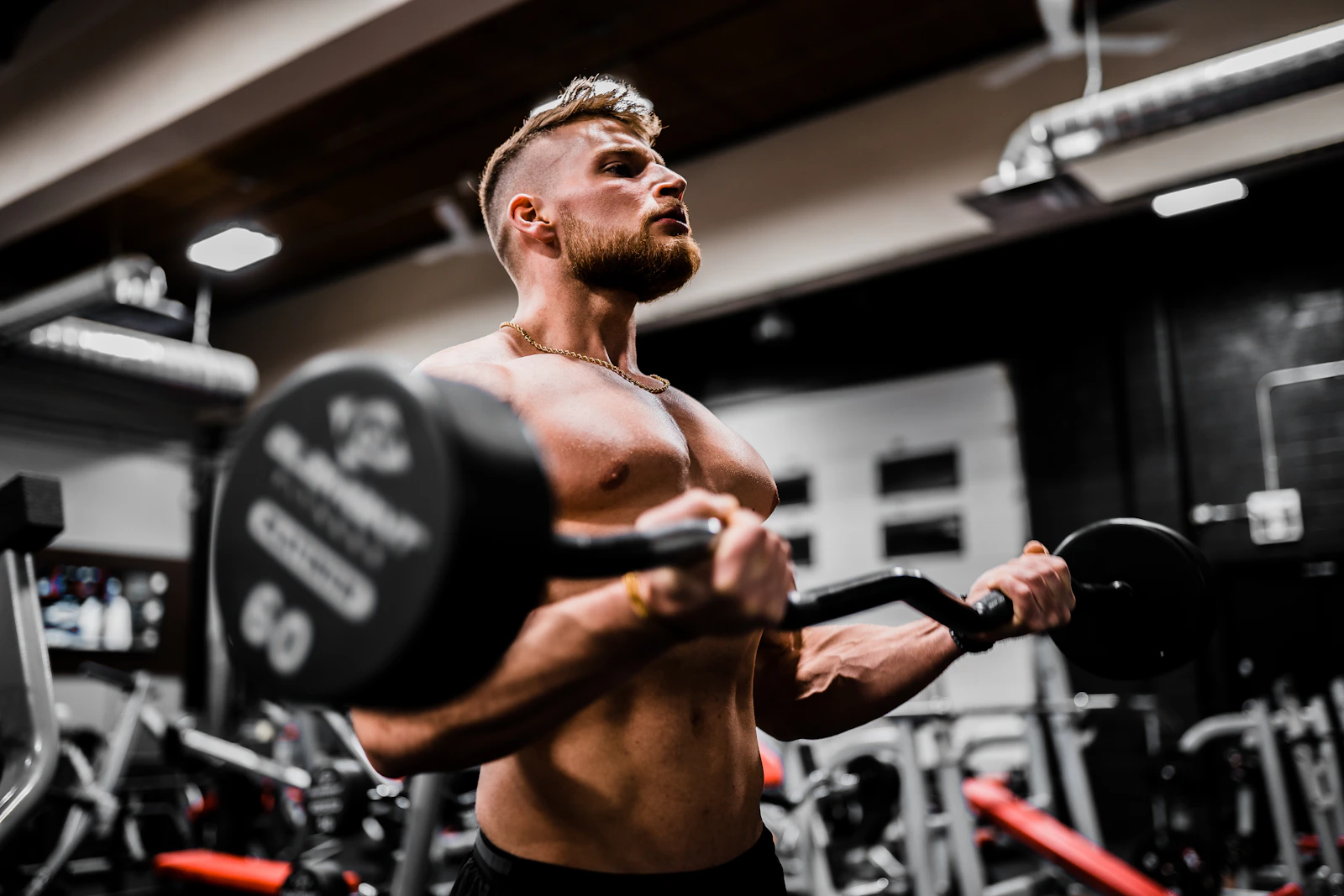 Athlete performing a loaded curl in a gym