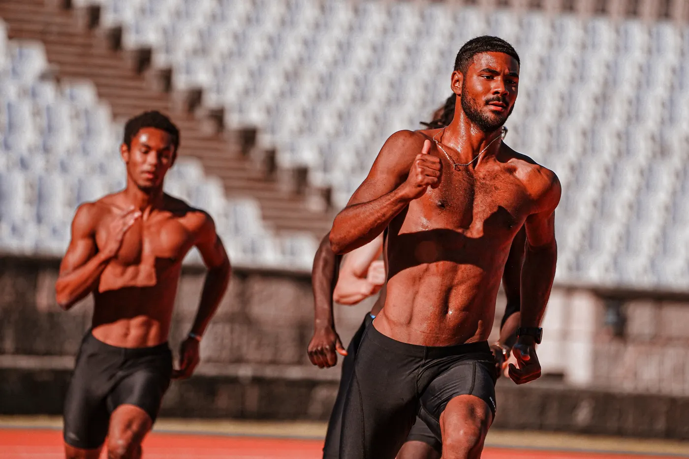 Several athletes sprinting together on an outdoor track