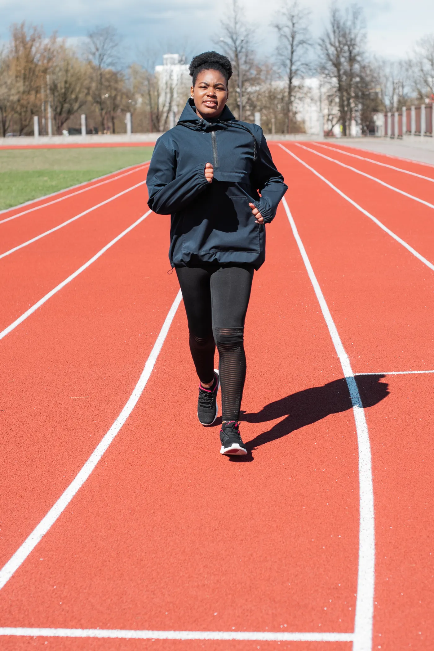 Woman running on an athletics track