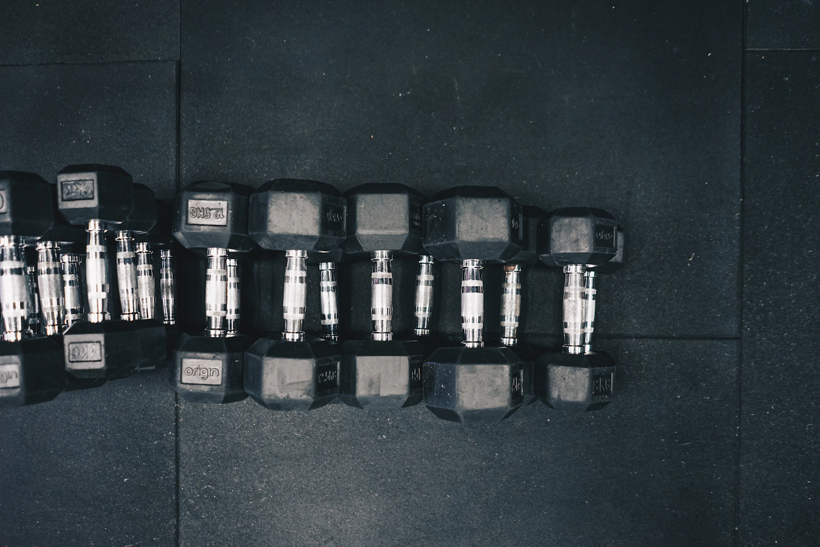 Row of black hex dumbbells prepared for a strength-training session