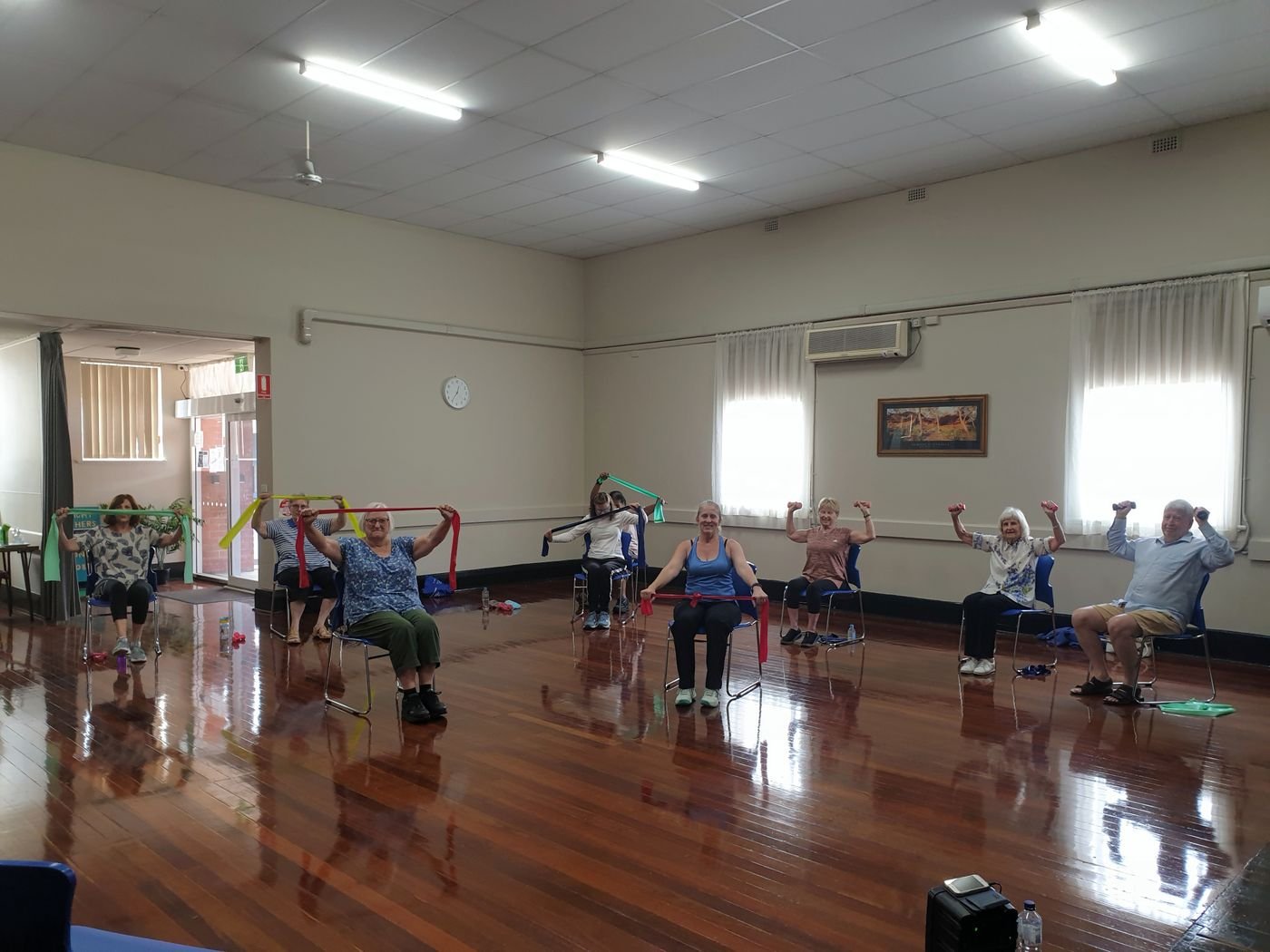 Older adults participating in a supported chair exercise class