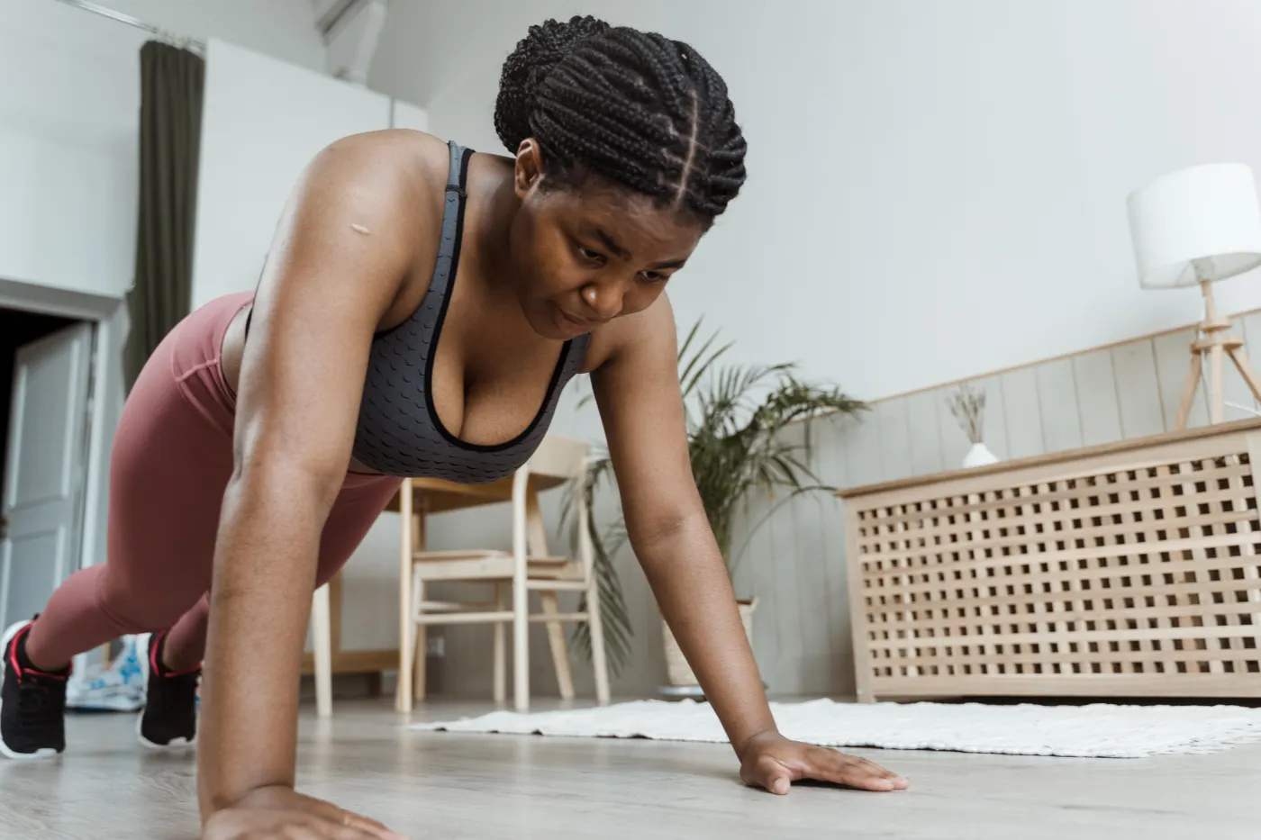 Woman performing a floor push-up indoors
