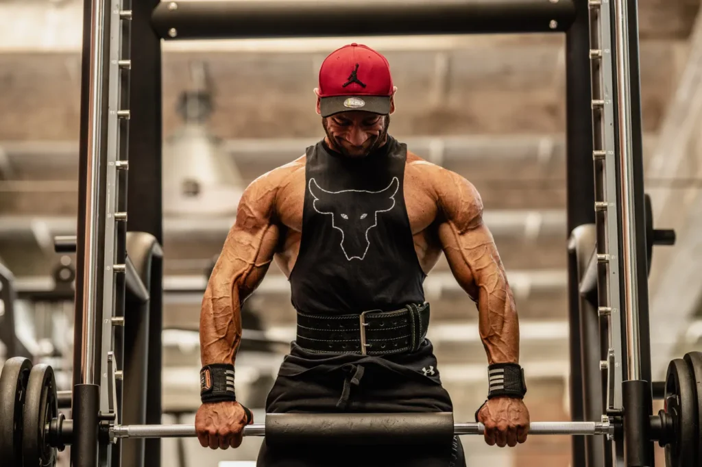 Muscular lifter training with a heavy barbell in a strength gym