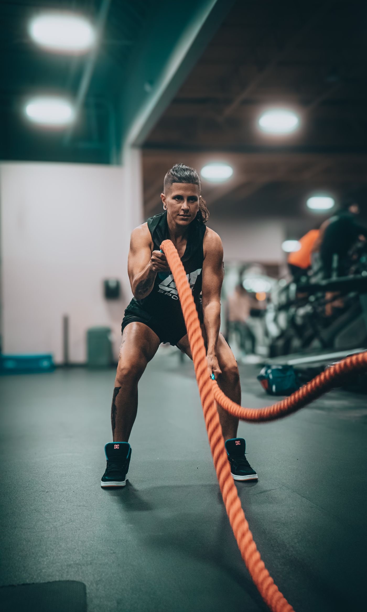 Athlete driving battle ropes during an intense conditioning workout