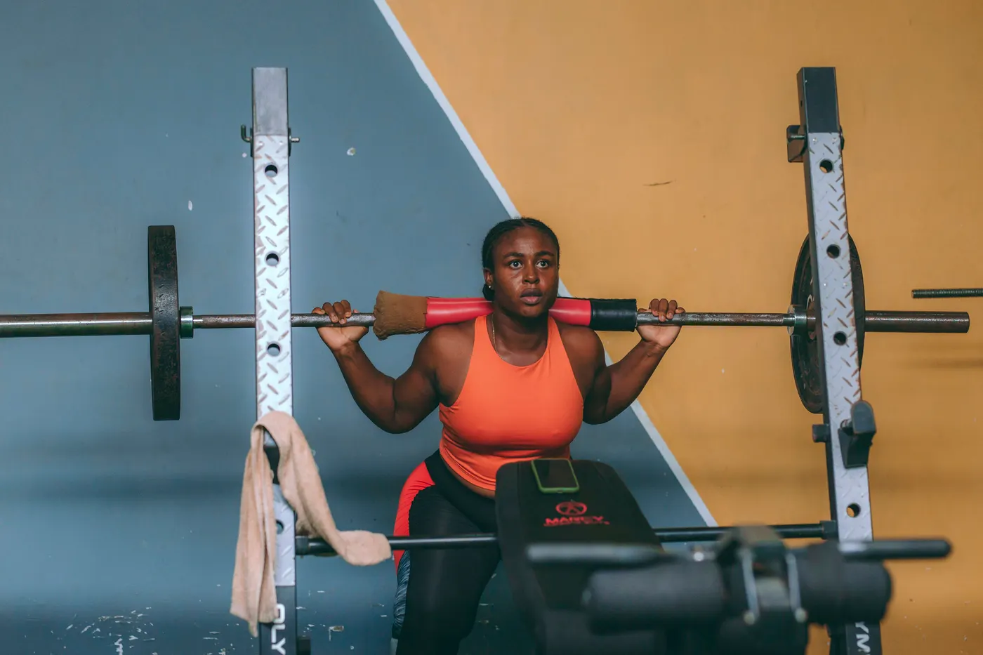 Woman lifting weights in a gym in Accra, illustrating general resistance training