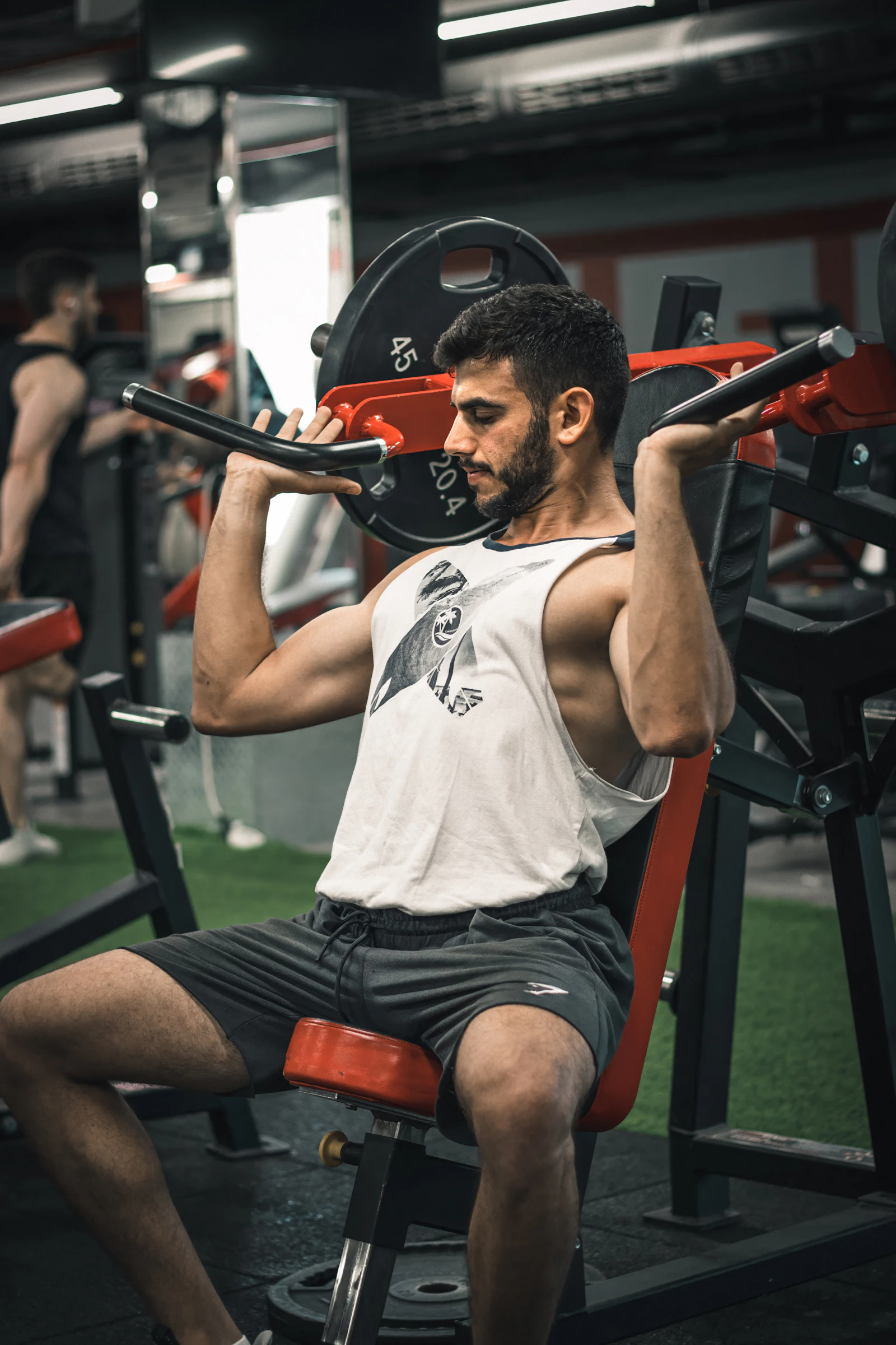 Lifter resting seated on a weight bench near a barbell