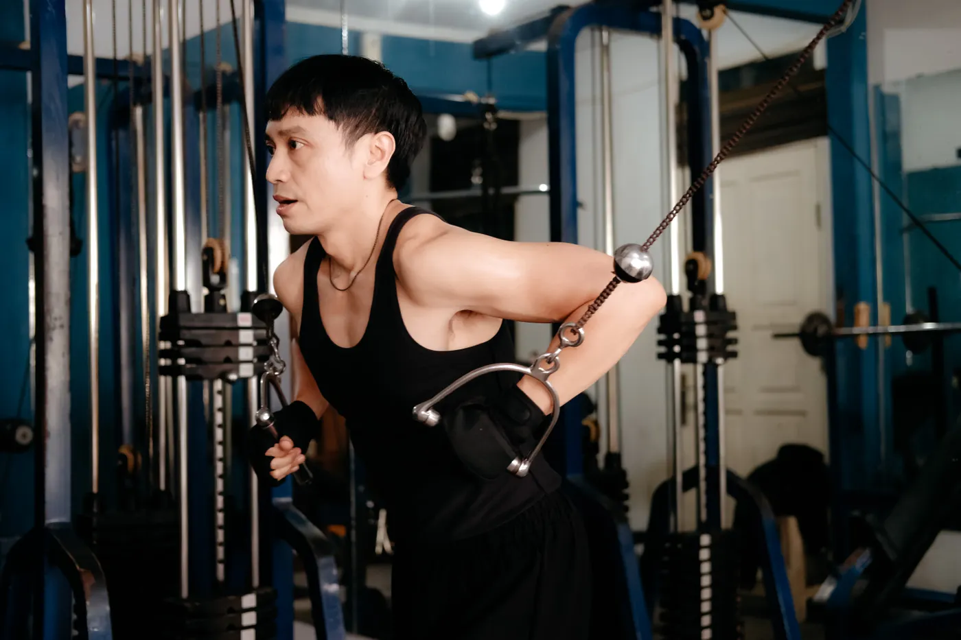 Man performing a cable triceps exercise