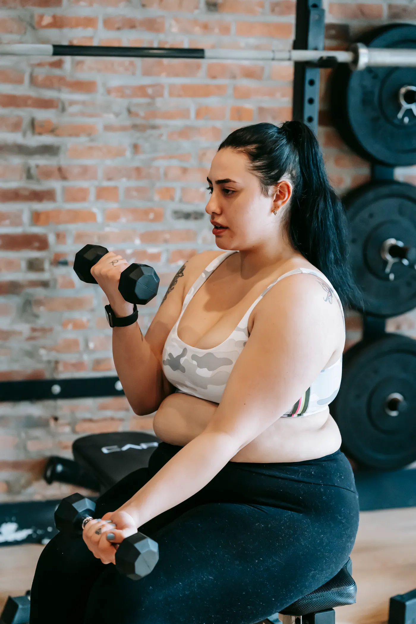 Woman performing dumbbell strength exercise
