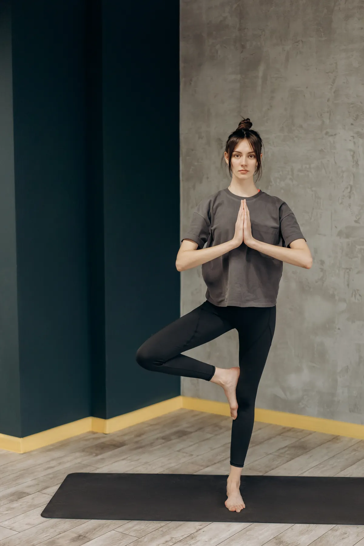 Woman balancing on one leg in a yoga tree pose
