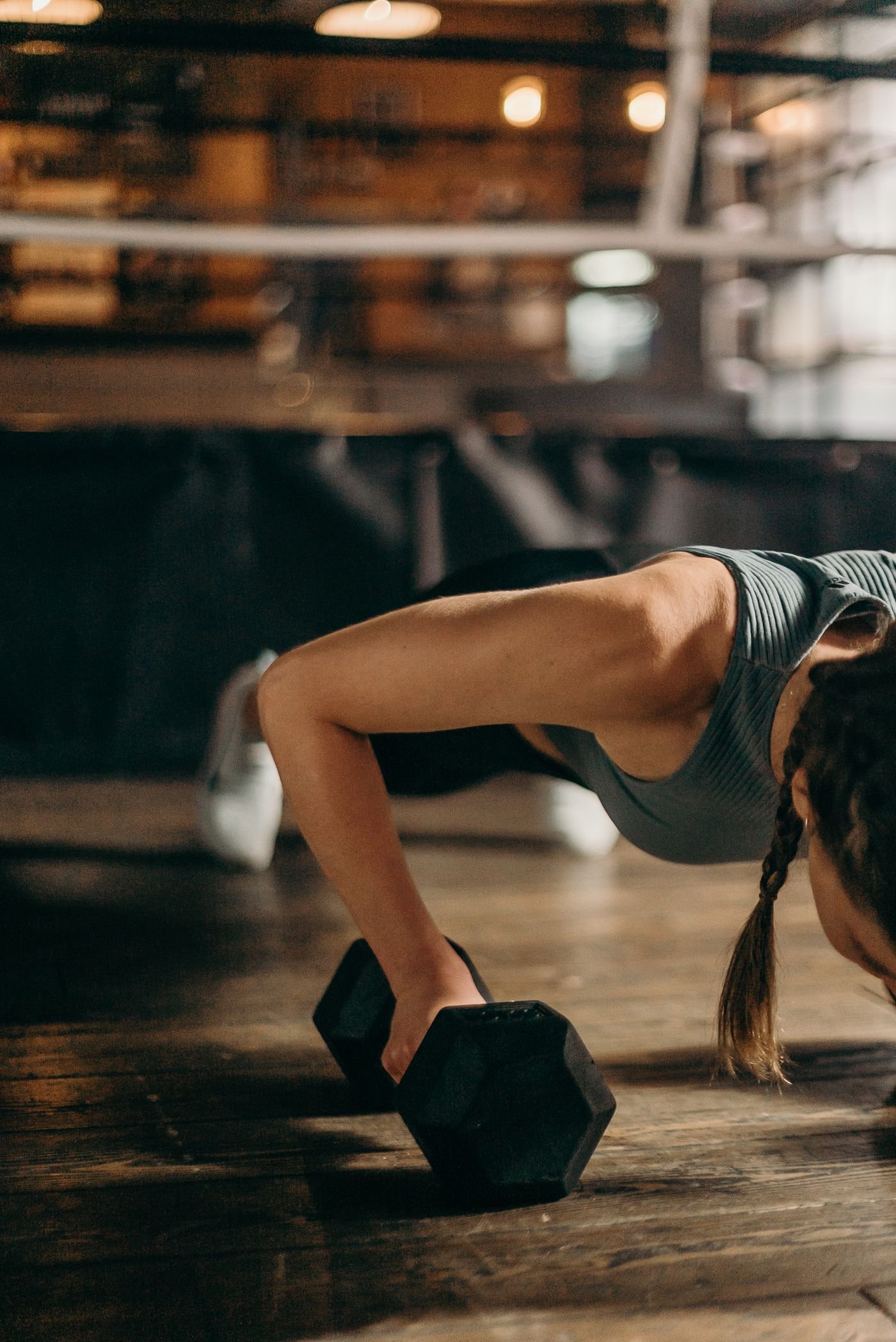 Woman performing a dumbbell-supported push-up