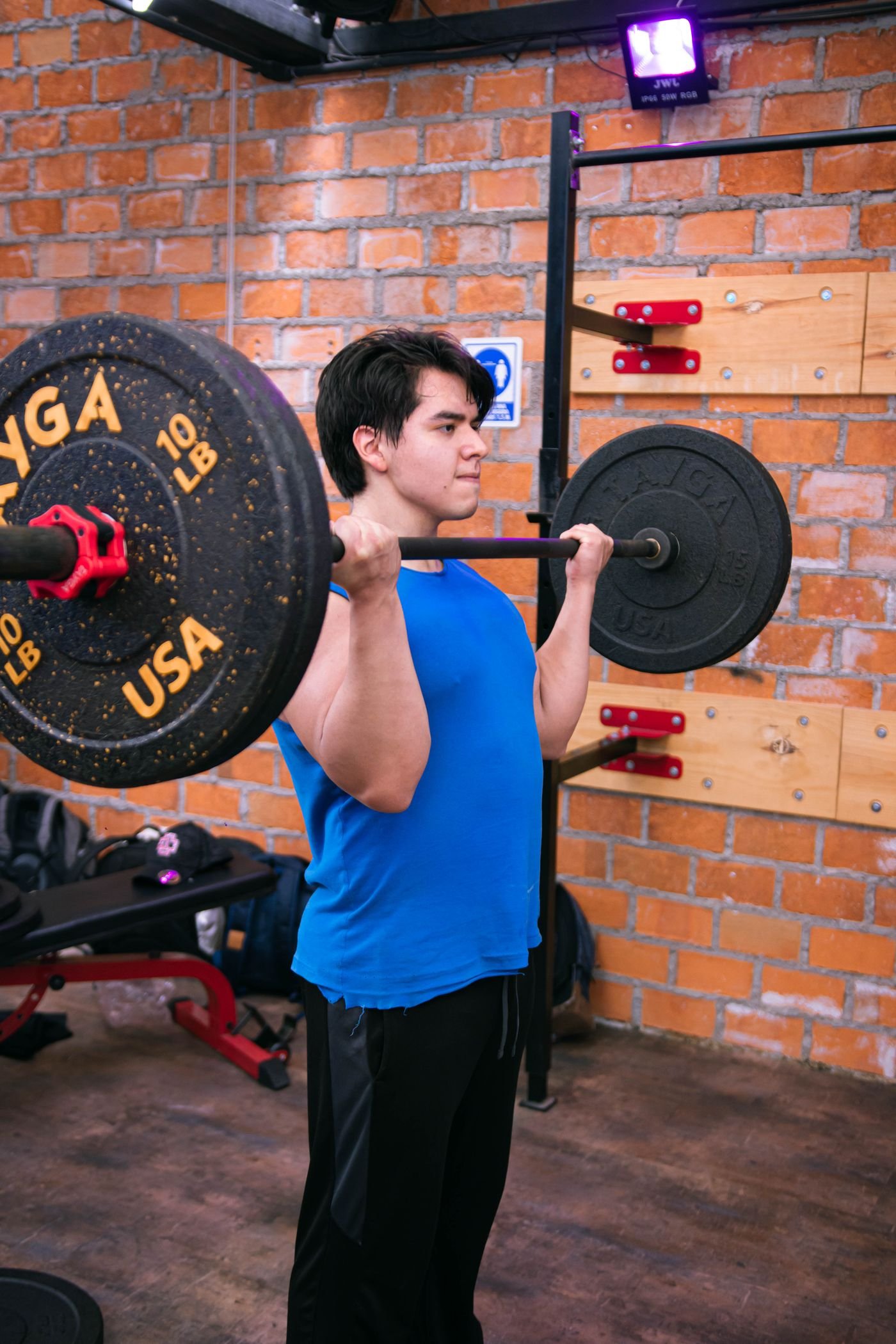 Lifter performing a barbell deadlift in a gym