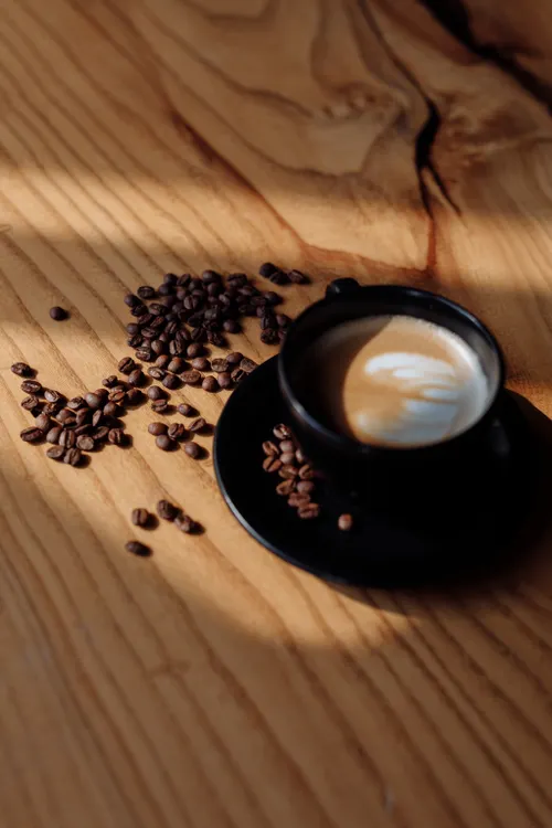 Cup of coffee and beans illustrating caffeine serving size