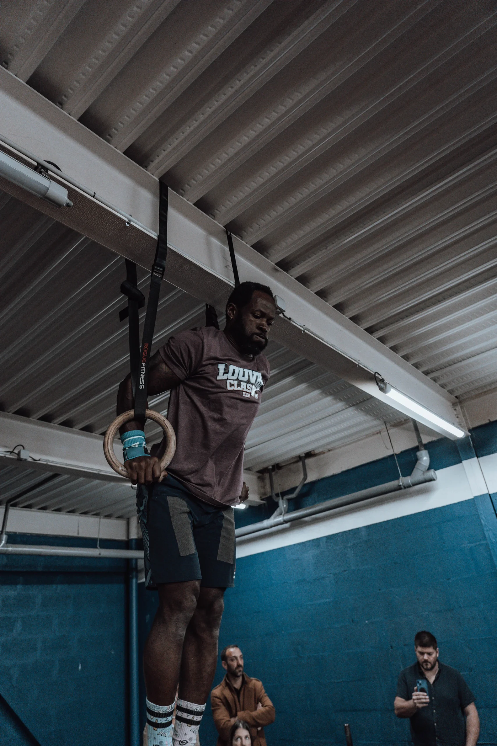 Athlete hanging from a pull-up bar to challenge supporting grip