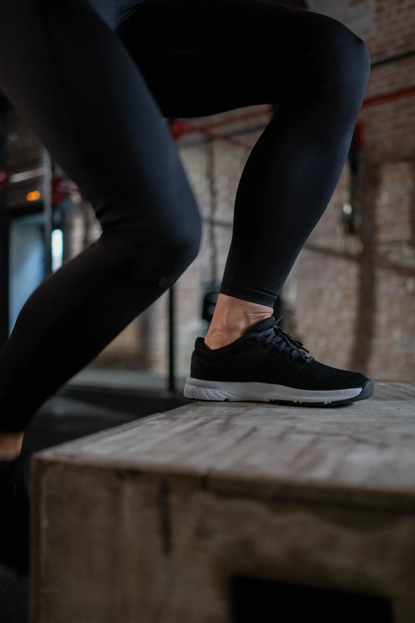 Close-up of an athlete's feet and legs during a plyometric box jump