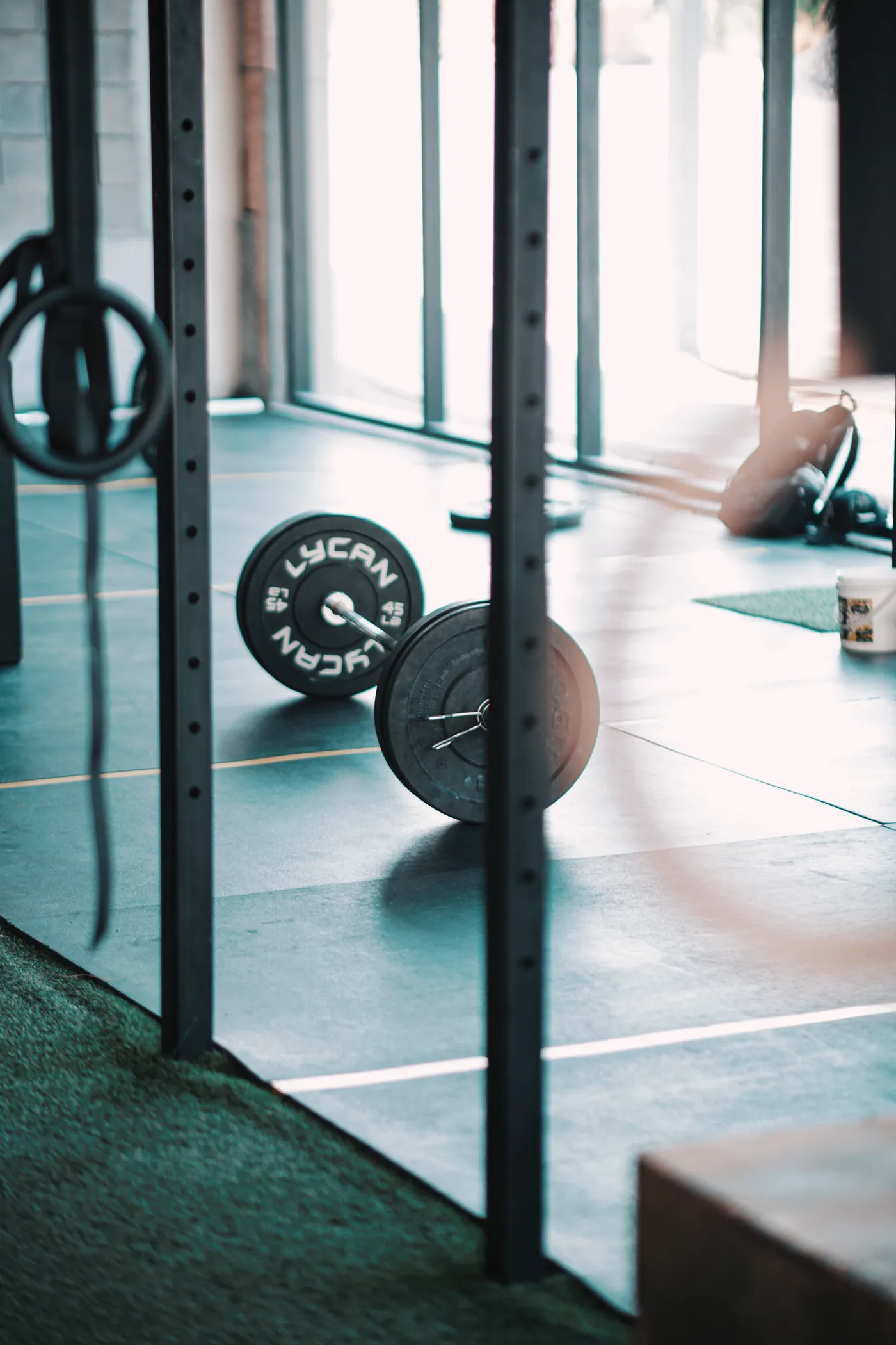 Unloaded barbell resting on a gym floor