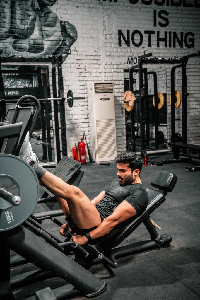 Athlete using a leg press machine for controlled lower-body strength training