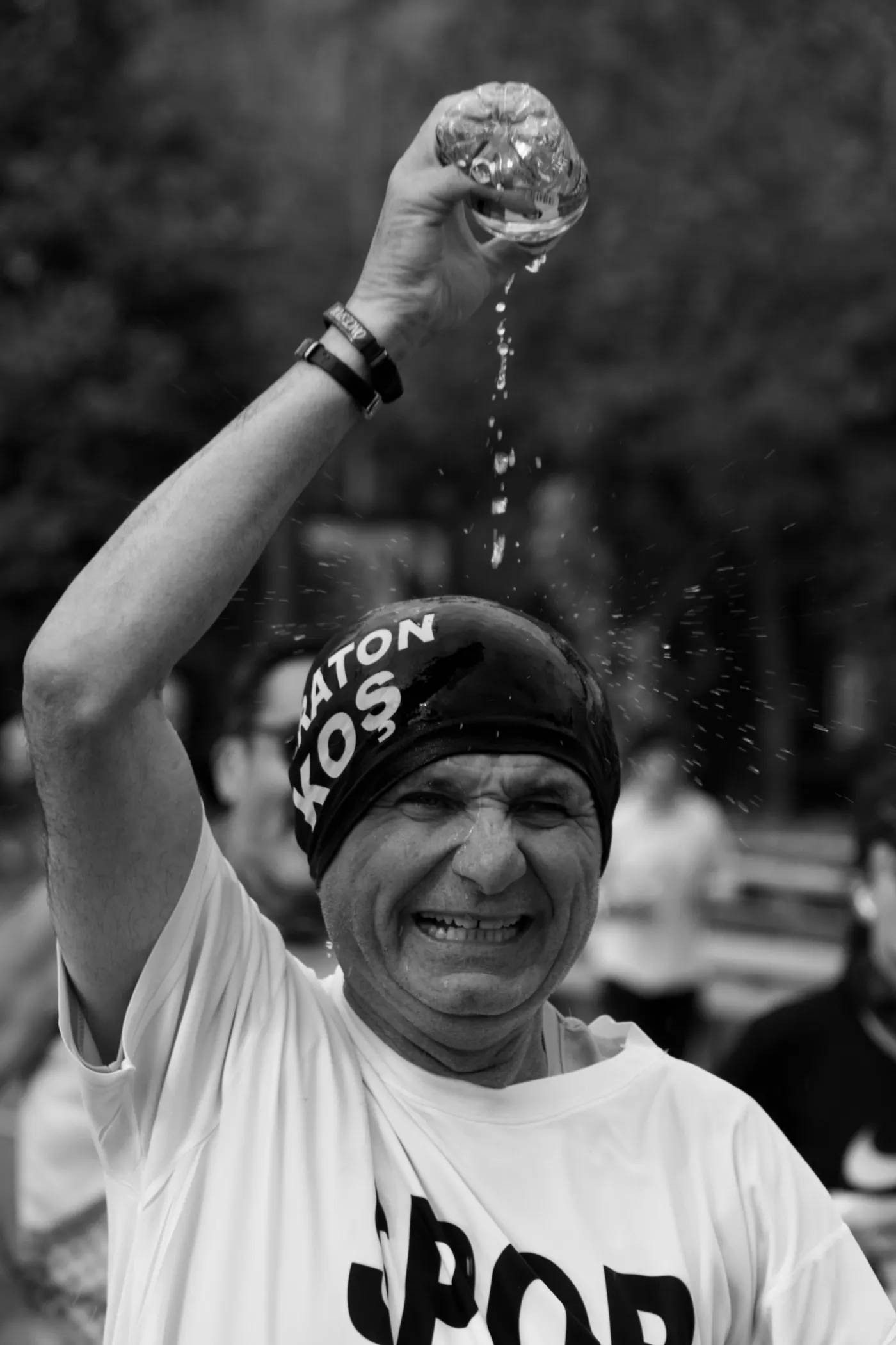 Distance runner cooling down with water during a marathon
