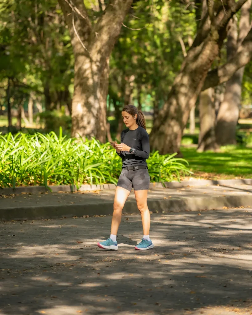 Woman jogging on a sunlit park path