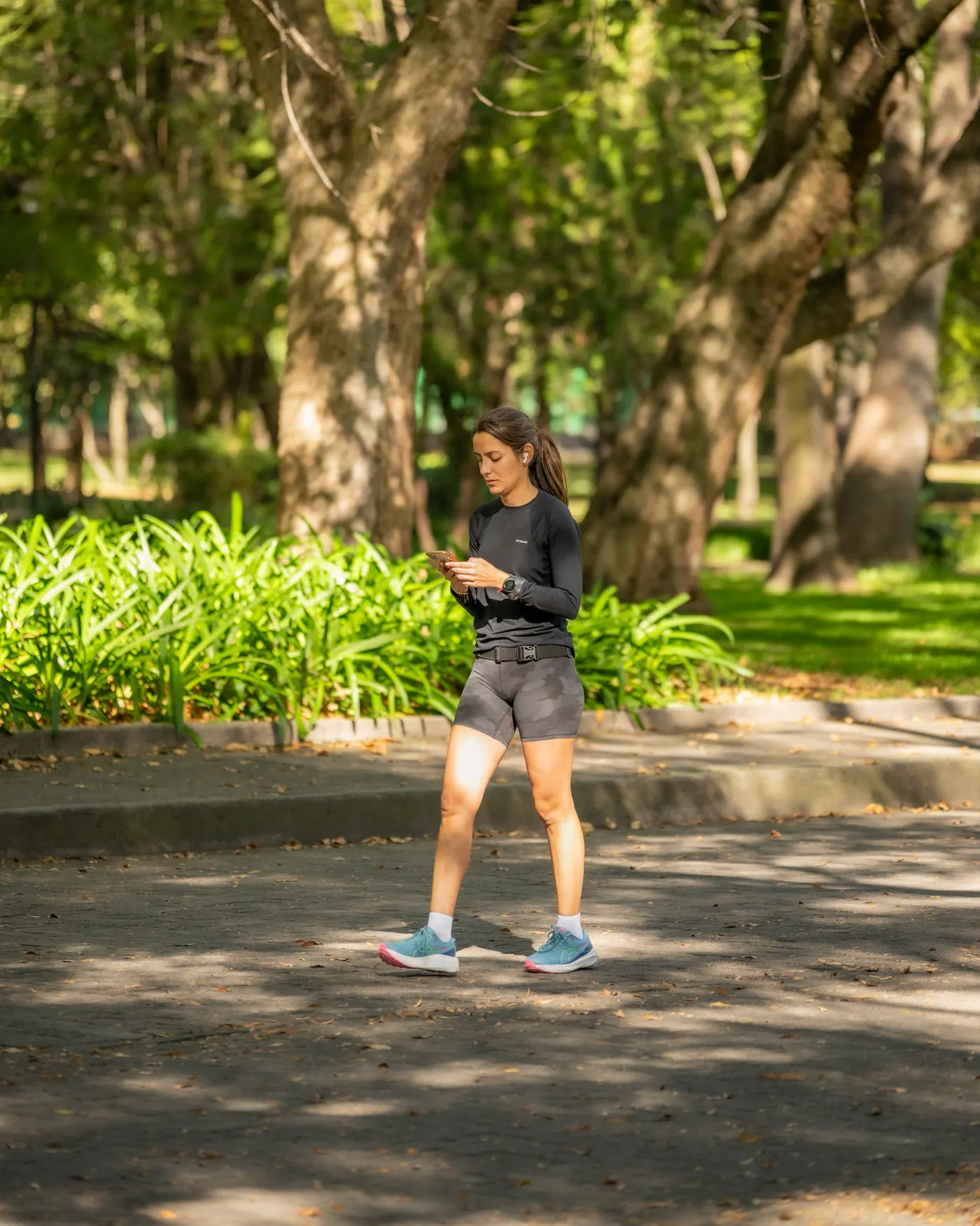 Woman jogging on a sunlit park path