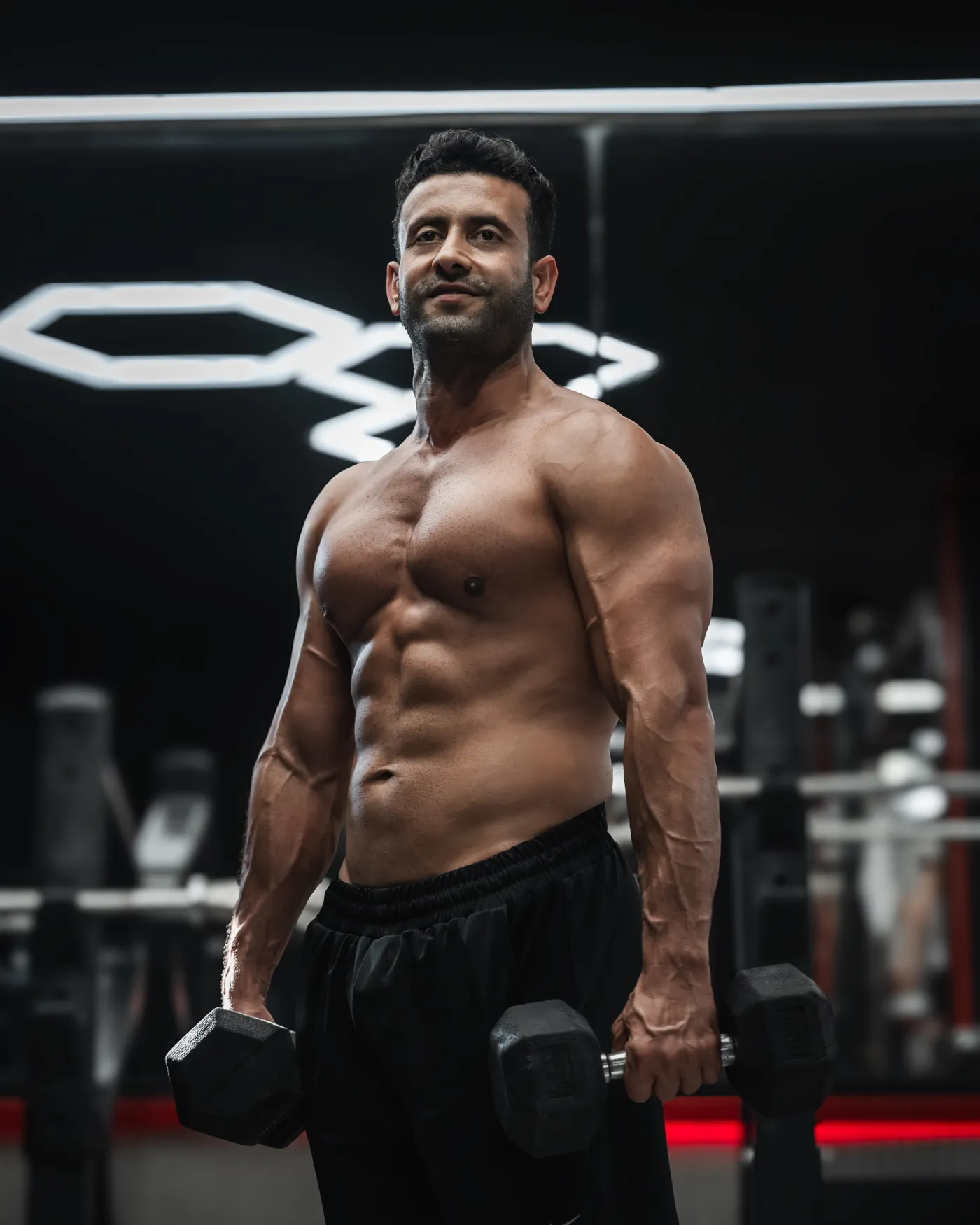 Athlete training with dumbbells in a gym