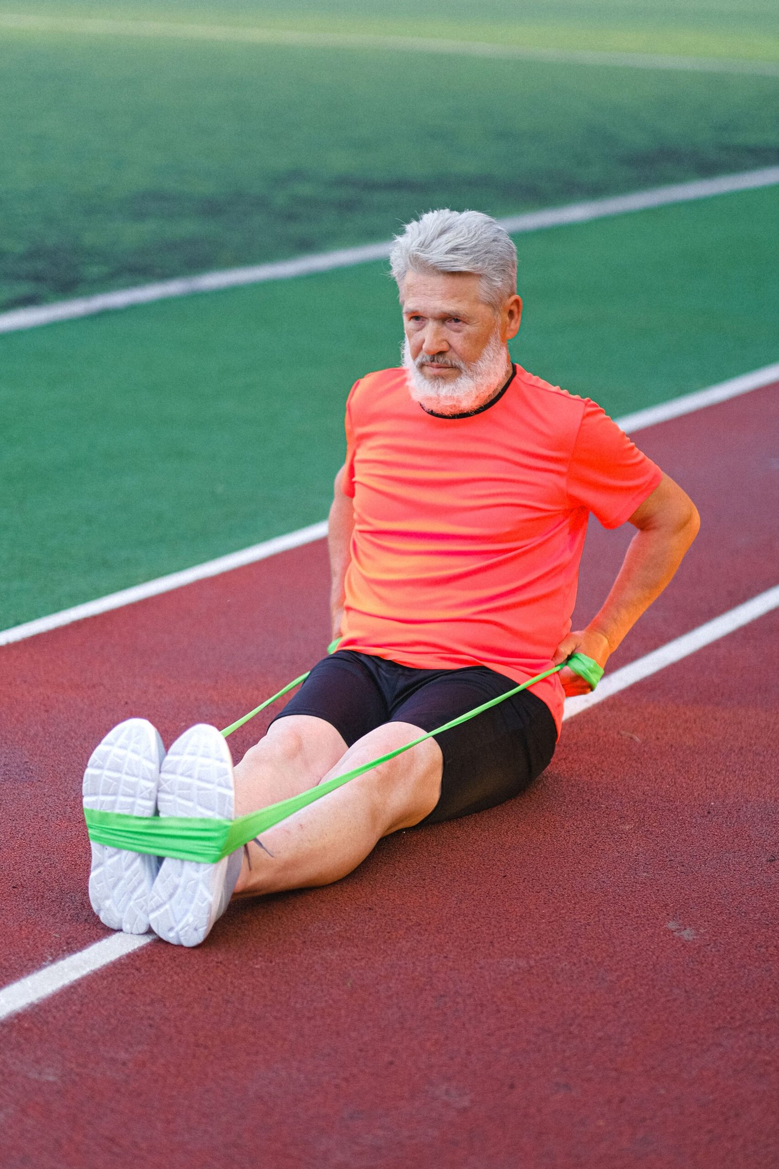 Older man exercising with a resistance band outdoors