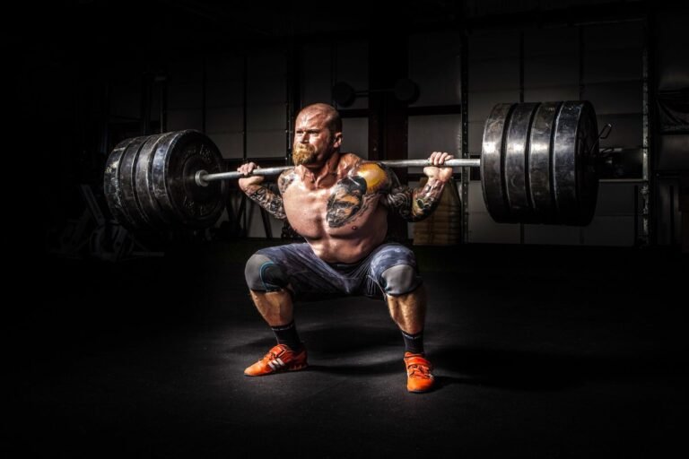 Powerlifter performing a heavy barbell squat in the gym