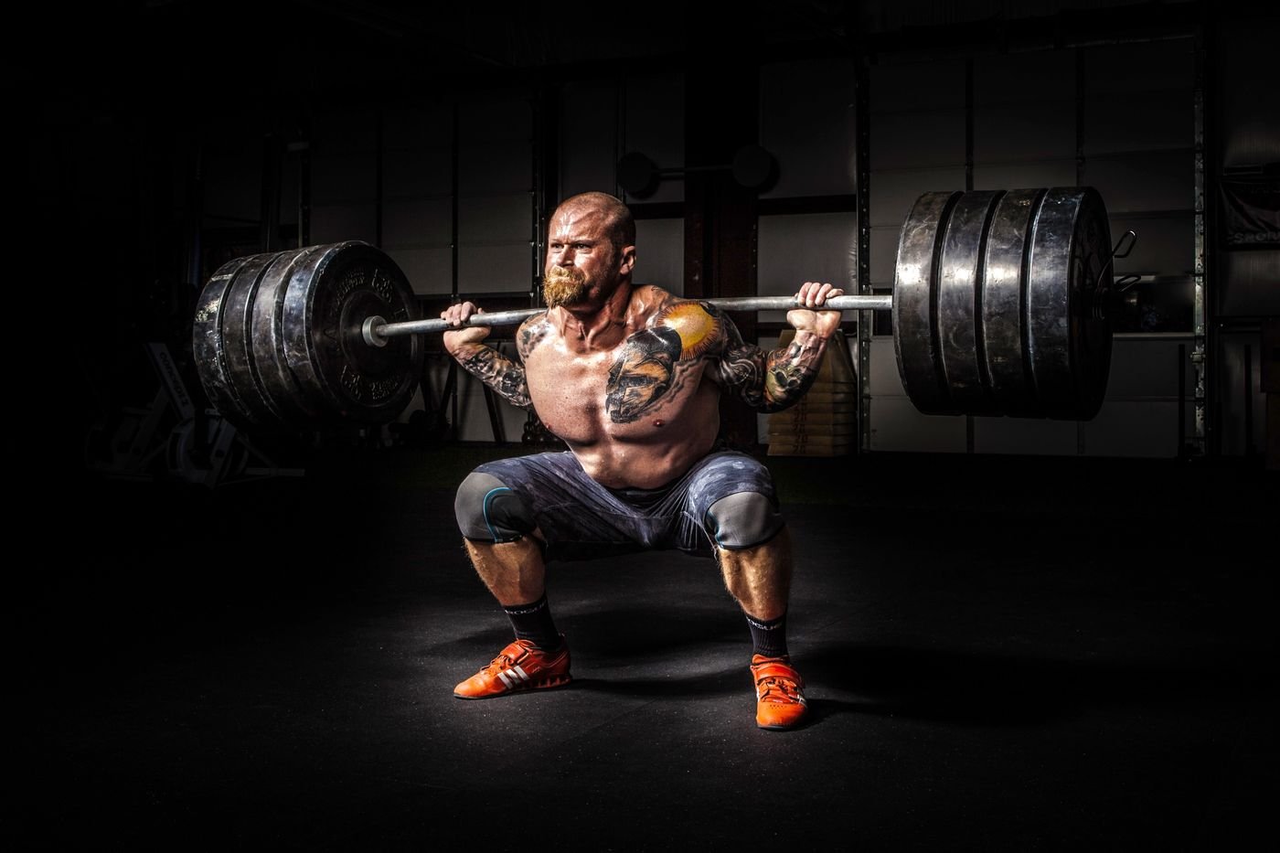 Powerlifter performing a heavy barbell squat in the gym