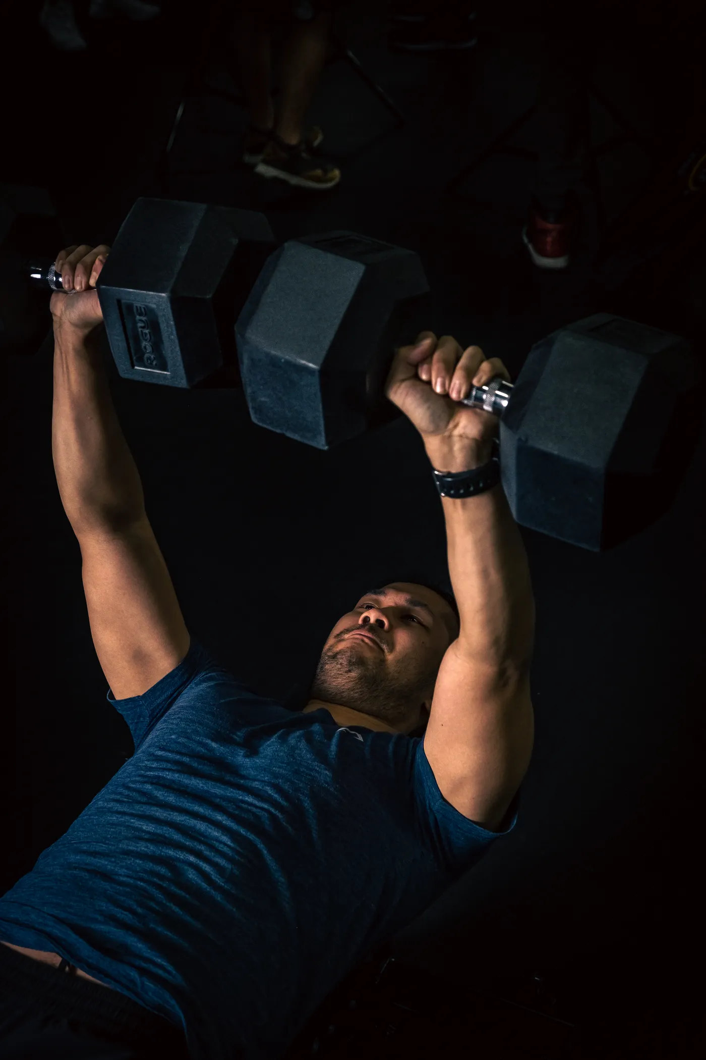 Lifter exerting effort during a dumbbell exercise