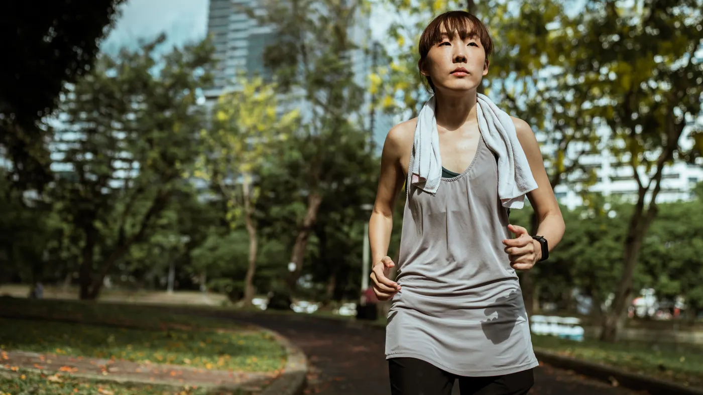 Woman running on a sunlit park path