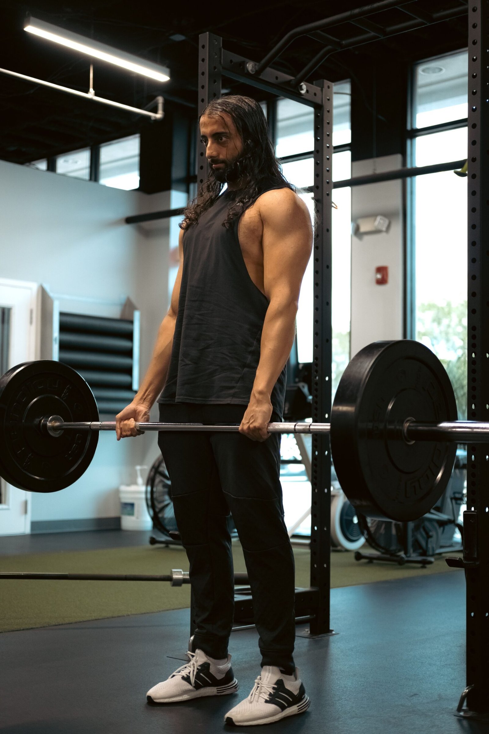 Strength athlete lifting a loaded barbell in a gym
