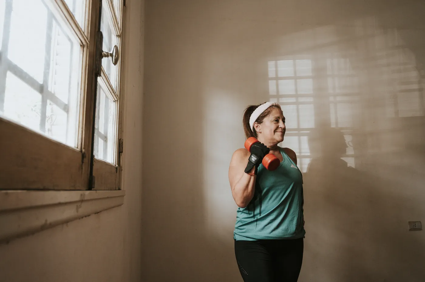 Older woman performing a controlled dumbbell exercise