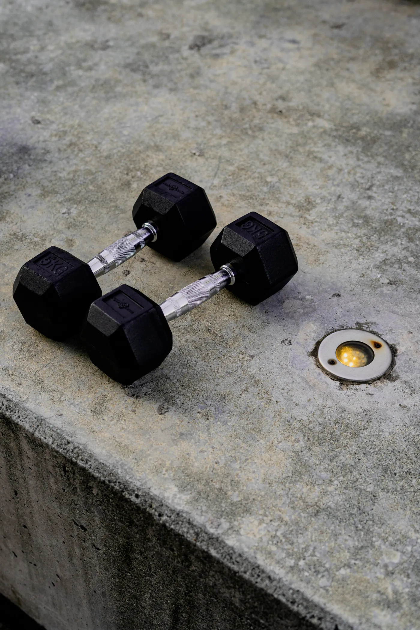 Pair of heavy hex dumbbells on a concrete gym floor