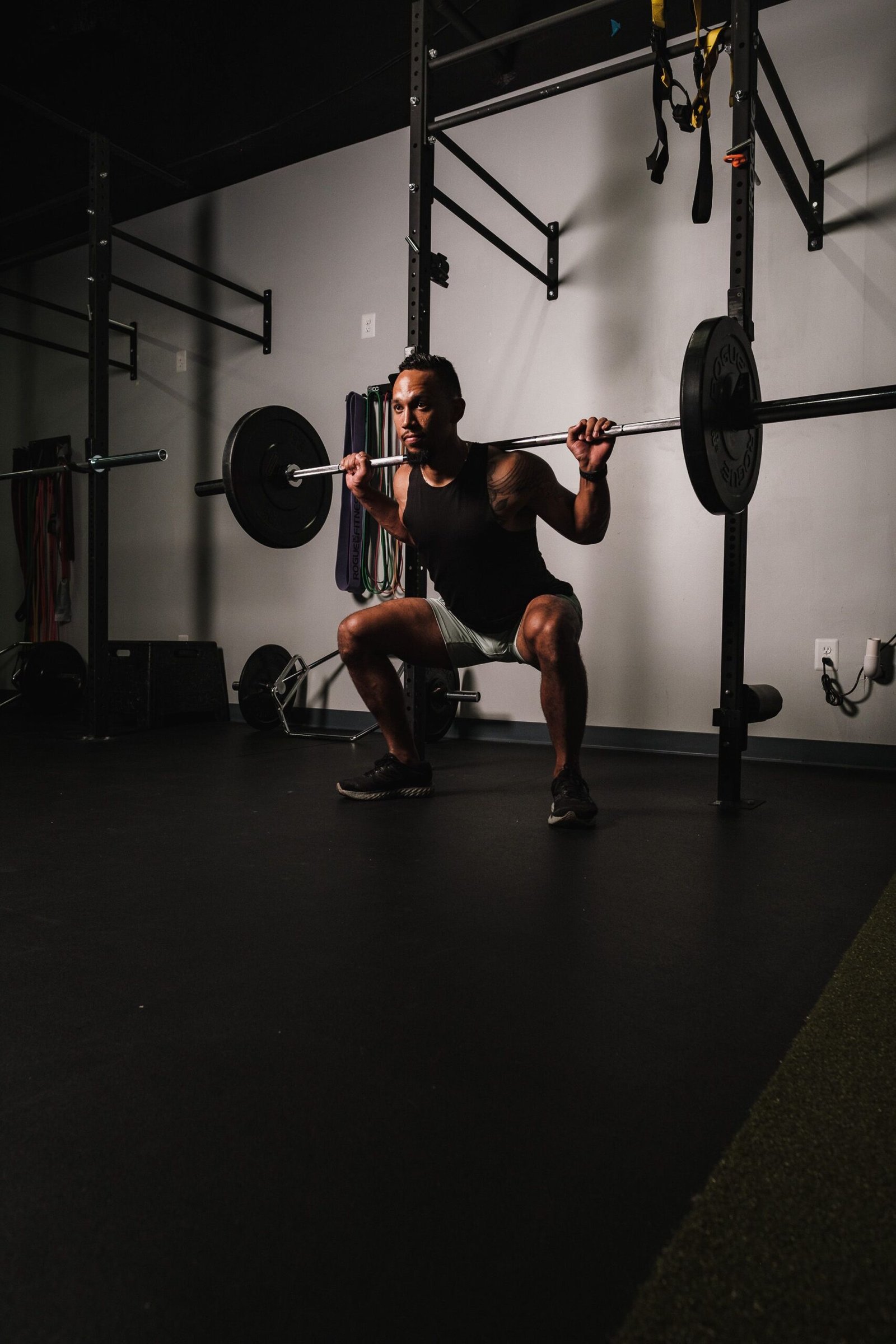 Man holding a barbell squat position