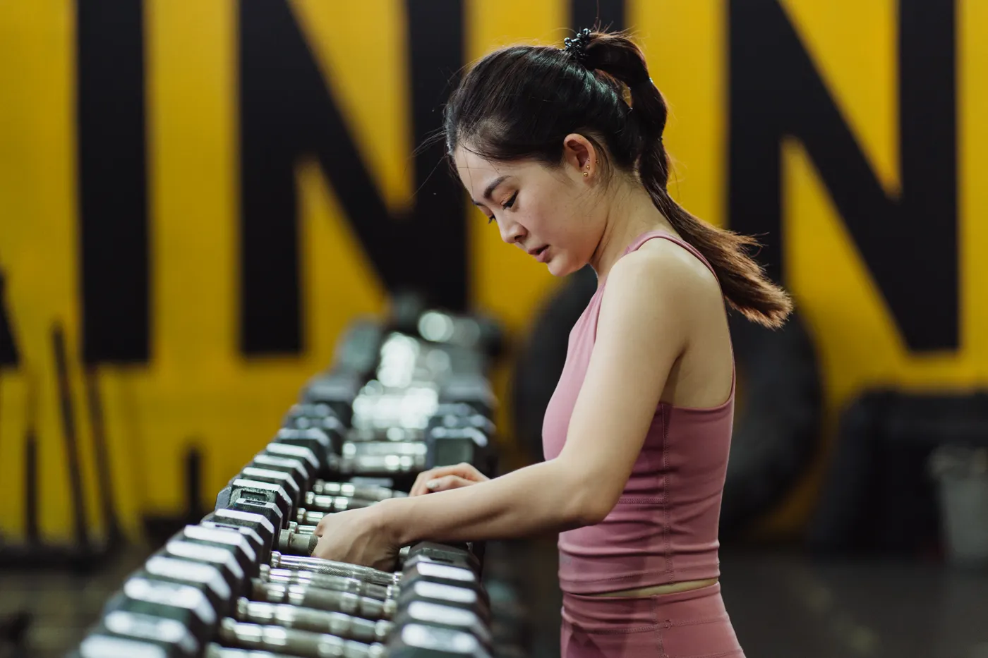 Woman selecting a dumbbell for a workout