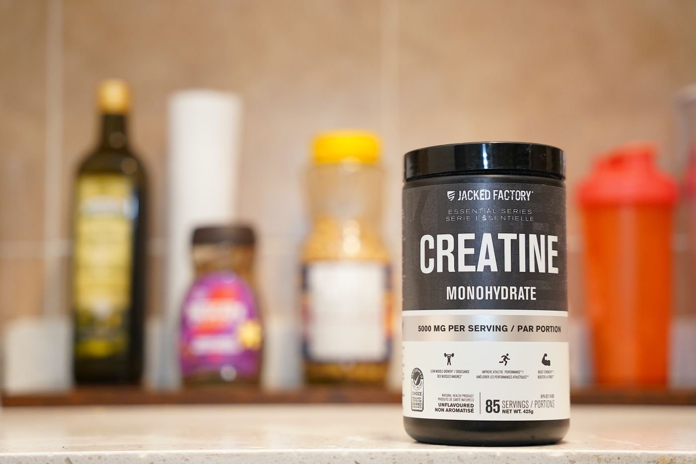 Container of creatine monohydrate on a kitchen counter
