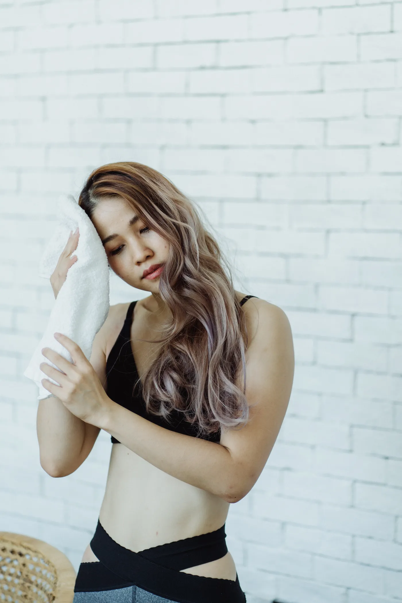 Woman using a towel to recover after a fitness session