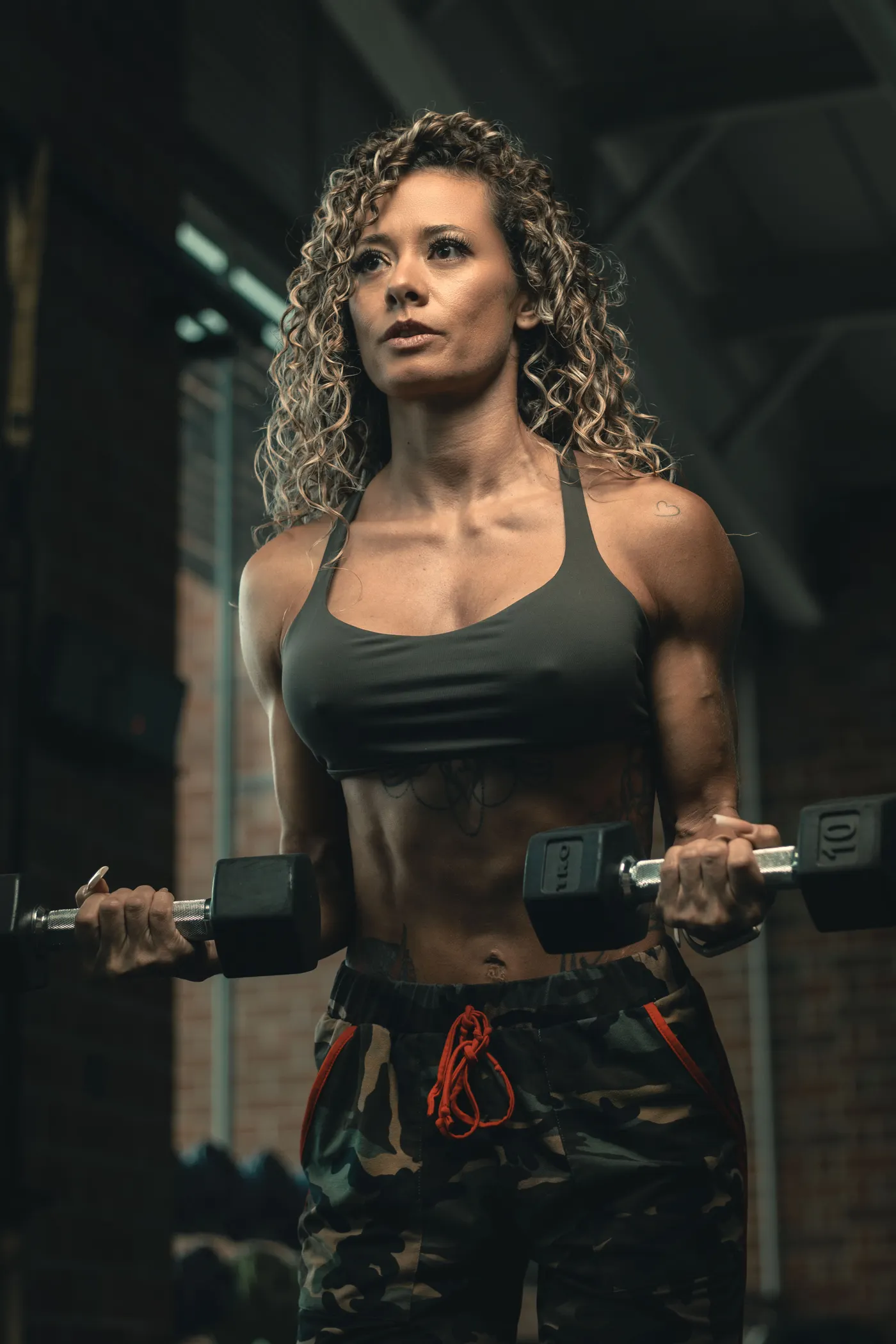 Woman lifting dumbbells in a gym, illustrating resistance training