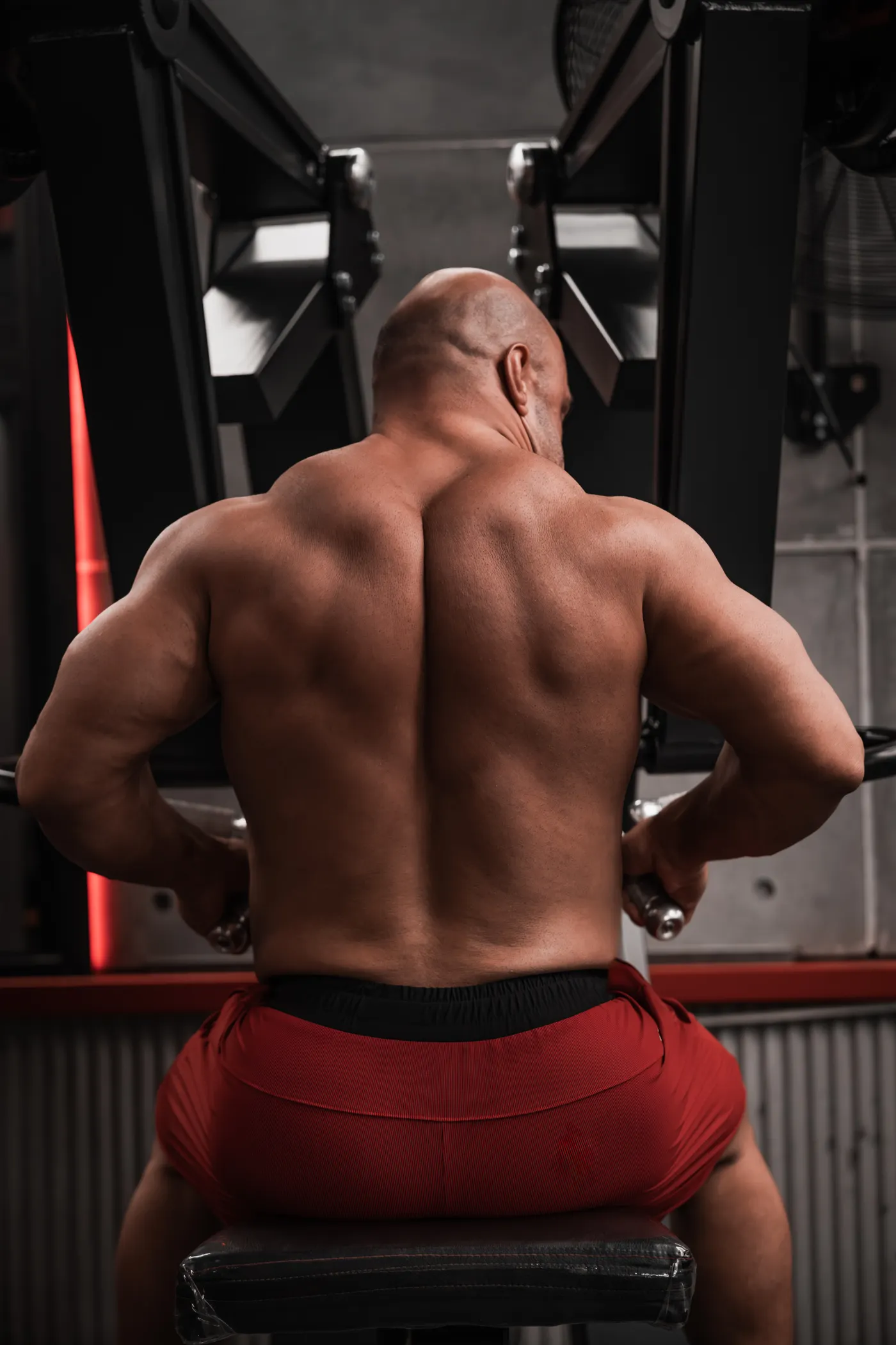Man using a resistance training machine in a gym