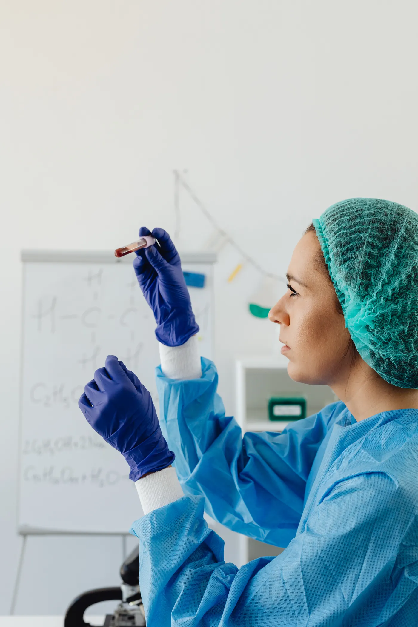 Female scientist examining a blood sample in a laboratory