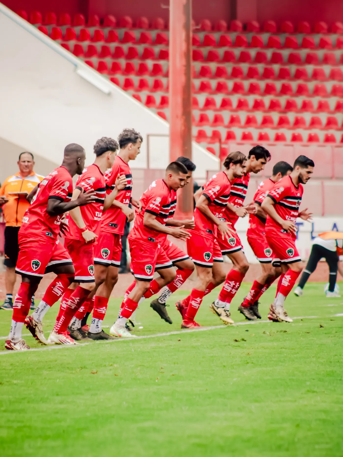 Soccer team practicing coordinated drills on a grass field