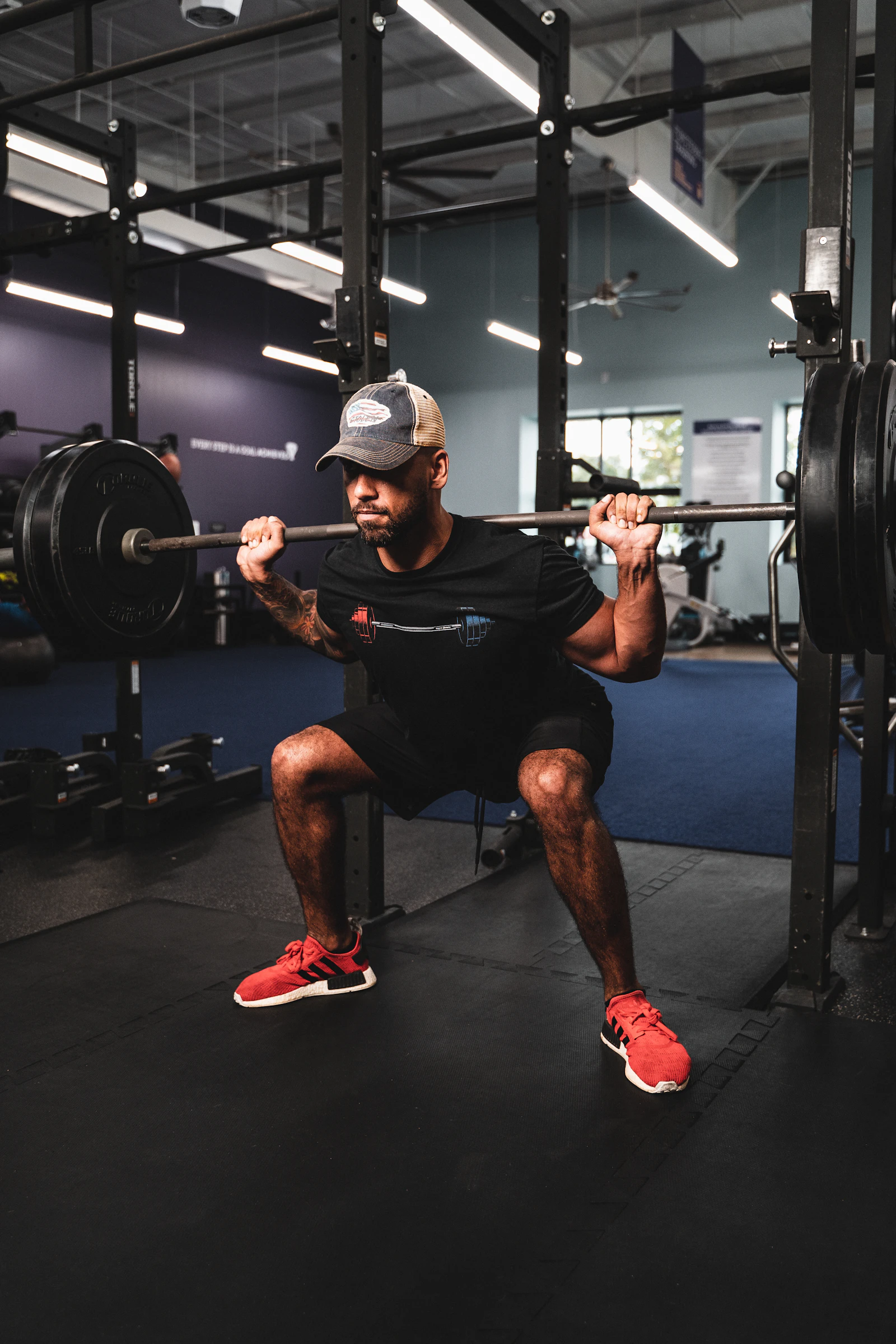 Athlete performing a squat with weights in a gym