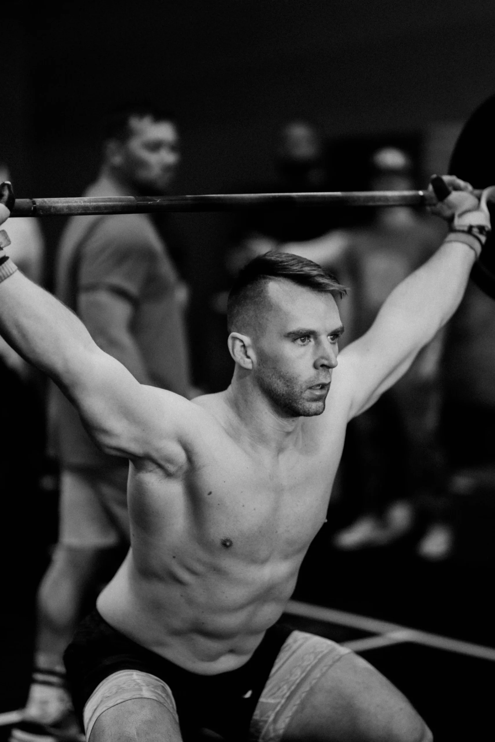Weightlifter maintaining a firm grip on a loaded barbell