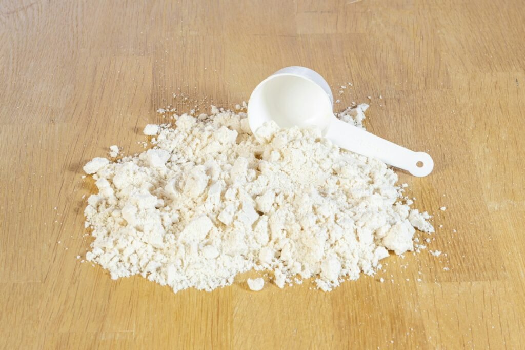 Whey protein powder and a measuring scoop